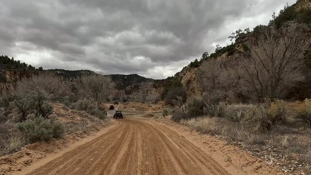 Utah river crossing desert trail off road recreation POV 4K. Recreation off road, nature exploring. Desert mountain canyon valley trail ride area. Rocky, forest, desert hill, river crossings.