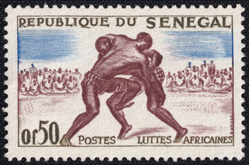 Postage stamp from Senegal featuring traditional African wrestling, known as Laamb. Two wrestlers...