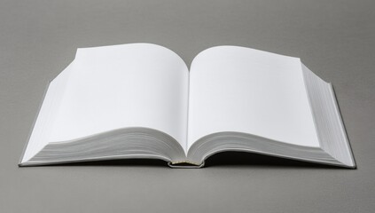Open book with blank pages on a gray surface