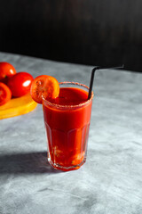 Refreshing vegetable cocktail. Tomato juice served in glass with tomato slice. Image for menu, bars, restaurants