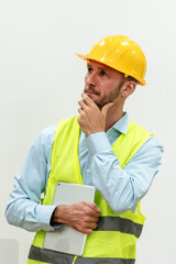 Portrait Caucasian engineer man holding digital tablet and thinking 