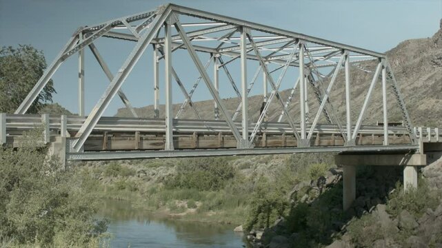 Man on One Wheel Rides Accross Junction Bridge in Taos high angle