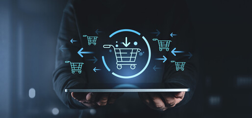 Online shopping concept with holographic cart icons floating above a tablet.