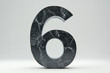 A large black number six is sitting on a grey surface
