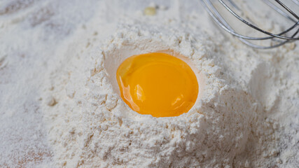 An egg in a flour well