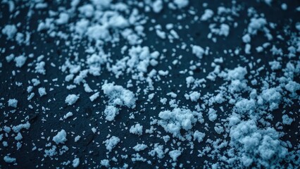 Obraz premium Delicate flakes gently fall on dark snowy ground, serene, white flakes