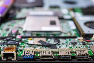 Close-up of the inside of a laptop motherboard with various connection ports USB LAN Network HDMI. Modern technology.