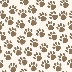 Seamless pattern with cat tracks on beige background 