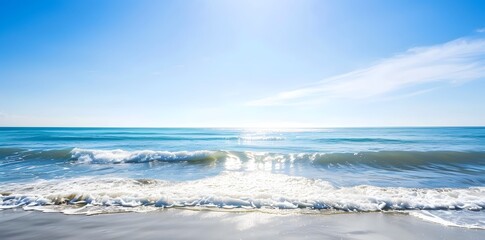 Serene sea view stretching toward the horizon under a vast, cloudless blue sky.