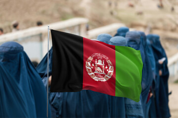 Afghan Flag Displayed Over Group of Women in Traditional Blue Burqas