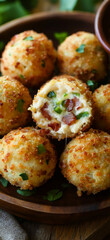 Fototapeta premium Crispy jalapeno popper cheese balls with bacon, garnished with fresh parsley, served with a spicy dipping sauce.