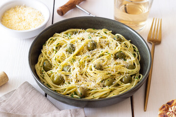 Pasta spaghetti with olives, herbs and cheese. Healthy food. Italian cuisine. Vegetarian food.