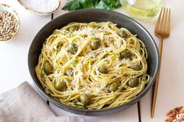 Pasta spaghetti with olives, herbs and cheese. Healthy food. Italian cuisine. Vegetarian food.