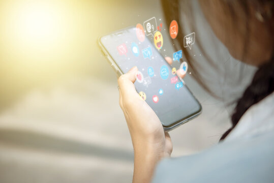 Online communication through a mobile phone with interactive social networking apps. Social media engagement showing likes, messages, and notifications on a digital screen.