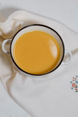 vegetable, vegan soup with cauliflower, carrot, pumpkin on white background with kitchen  textile table napkin