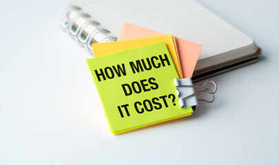 Obraz premium A yellow and orange sticky note with the words How much does it cost written