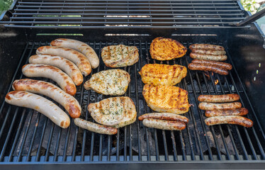 Barbecue grill bbq on propane gas grill steaks bratwurst sausages meat meal