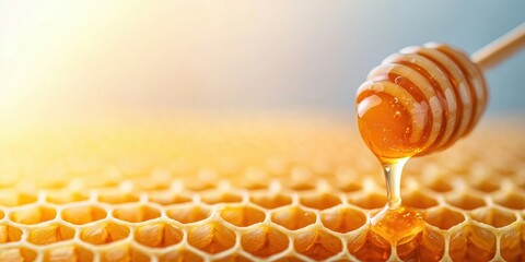 World bee day with nature and sustainability idea. Close-up of honey dripping from a wooden dipper onto a honeycomb.