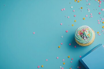 Delicious Birthday Cupcake with Pastel Frosting and Sprinkles on Blue Background
