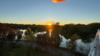 &ldquo;Sunset over Bucharest park river with green nature and calmness.&rdquo;
