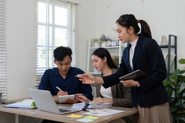 Strategic Planning and Discussion. A team collaborates on a project, analyzing important details and making decisions together.