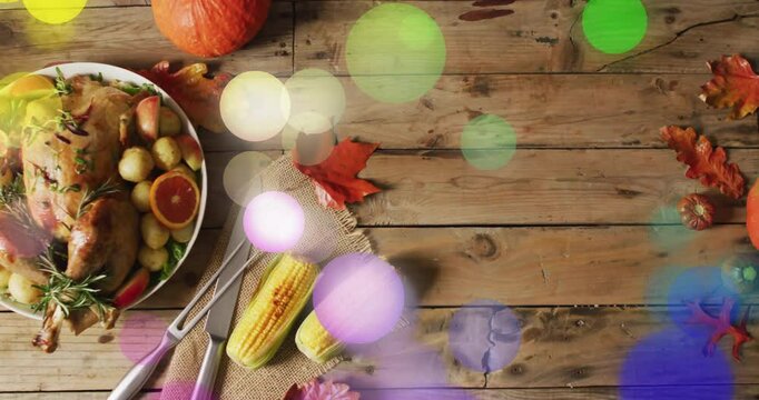 Thanksgiving dinner with turkey, corn, and autumn leaves decorating wooden table