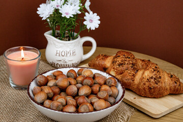Croissants and hazelnuts on the table. Delicious healthy breakfast. Top view