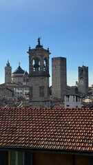 High panoramic view of Bergamo city with buildings, sunlight and scenery 