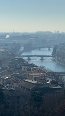 High panoramic view of Bergamo city with buildings, sunlight and scenery 