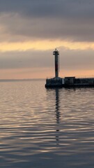 Sunset in the port of thessaloniki beautiful colors in the sky and the sea is calm and mirrors the ligths of the sun with the birds