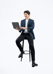Full body image of young Asian business man using laptop and sitting in chair on white background	