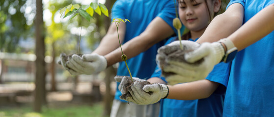 Environmental Stewardship and Team Spirit. Young volunteers showcasing their saplings for planting.
