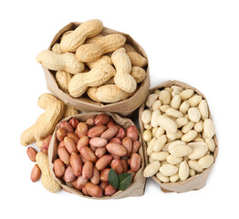 Different peanuts in paper bags isolated on white, top view