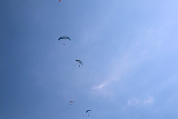 Paragliders soar in the air over the Dead Sea (Ölü Deniz). Parachuting. Tourist attraction. Fethiye, Mugla, Turkey.