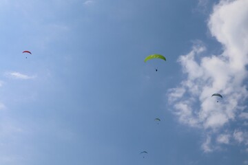 Paragliders soar in the air over the Dead Sea (Ölü Deniz). Parachuting. Tourist attraction. Fethiye, Mugla, Turkey.