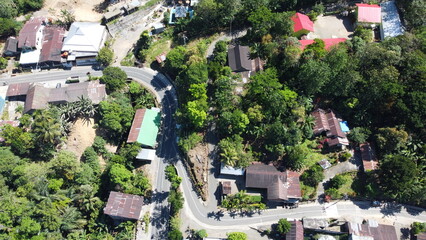 Aerial view of a winding road through a rural village with greenery