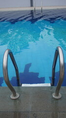Swimming pool with stainless steel handrails and clear water