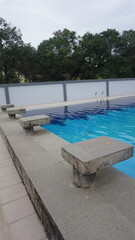 Outdoor swimming pool with concrete diving blocks