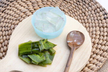 Fresh aloe vera leaves and slices arranged elegantly to highlight their soothing and hydrating...