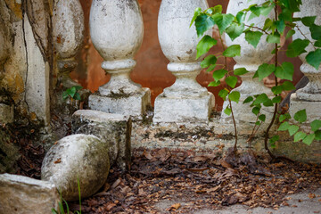 View of a dilapidated balustrade with concrete balusters at an old house