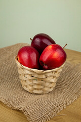 Red beautiful apples in a basket on the table. Red apples. Apple diet