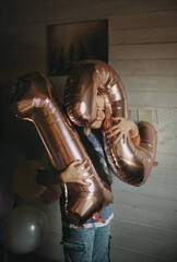 A girl holds the numbers 1 and 2 on her birthday