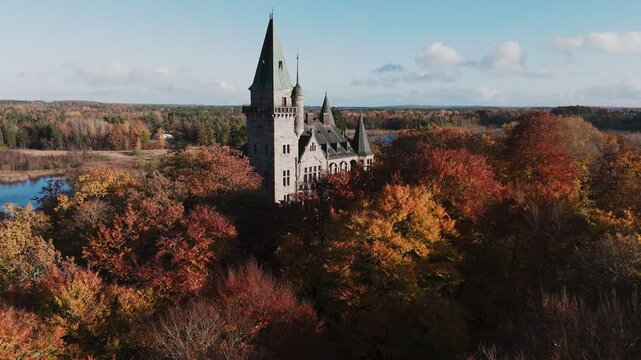 Tracking shot towards Teleborg Castle in V&auml;xjo, Sweden, Fall, Orange and Yellow Leafs, Sunset