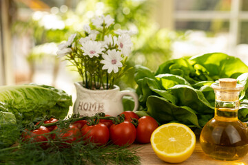 Red tomatoes, lettuce leaves on the table closeup. Vegetables for salad on table
