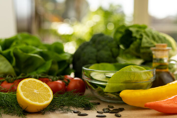 Red tomatoes, lettuce leaves on the table closeup. Vegetables for salad on table