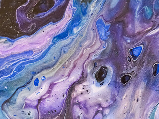 abstract fluid art painting with purple, blue and pink marble effect creating cosmic-like patterns