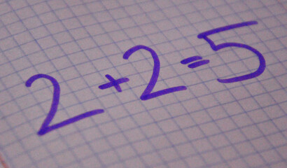 2+2=5 written on paper and pen. Wrong math operation.