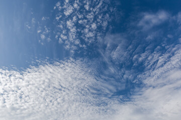 Blue sky with stratocumulus and cirrus clouds at sunny day