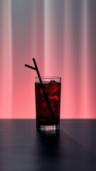 Colorful beverage in a glass glass filled with ice against a illuminated background
