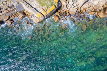 rocky beach as a background. Beautiful natural background at the summer time. Overhead drone top...